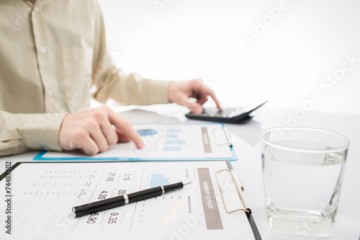 Close-up of graphs and charts analyzed by businessman