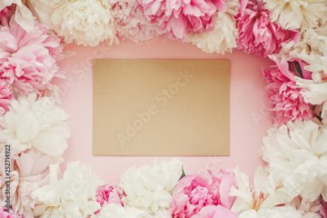 Empty greeting card in pink and white peonies frame on table, flat lay with space for text. Happy mother's day. International womens day. Birthday present