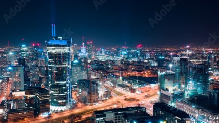 Aerial view of Warsaw business center at night: skyscrapers and Palace of Science and Culture