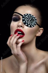 Fashion beauty woman portrait with shiny bandage on eye and red lips.