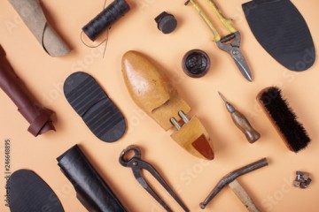 Tools for shoe repair on blue background