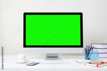 Design of workplace with computer green screen is standing on a desk in an office, Business Concept, copy space.