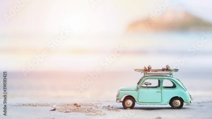Miniature tin car closeup at summer beach scene