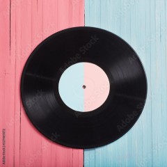 Music records on pink and blue wooden background. Retro music concept