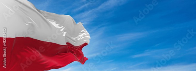 Large flag of poland waving in the wind against the sky with clouds on sunny day. 3d illustration
