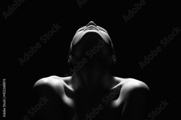 Nude Woman silhouette in the dark