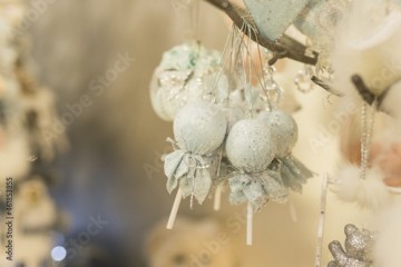 Close up of Christmas decorations with delicate blue toys on the branch