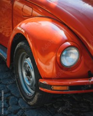 Closeup of a red old classic car in the street