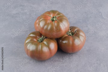 A stack of tomatoes on the marble background