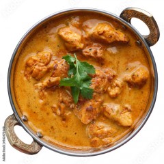 Indian butter chicken curry in balti dish top down view and isolated
