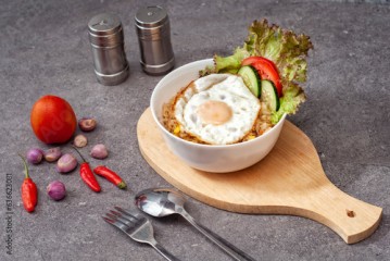 Rice Bowl — miska z azjatyckim daniem na desce do krojenia na stole