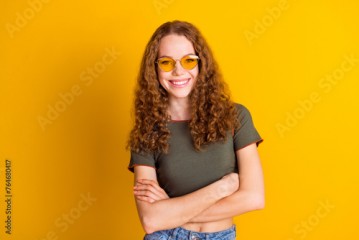 Photo of adorable gorgeous girl dressed nice outfit standing crossed arms isolated on yellow color background