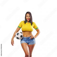 Beautiful young sporty Brazilian woman dressed in sportswear, playing with the ball, soccer and smiling. Isolated on free png background.