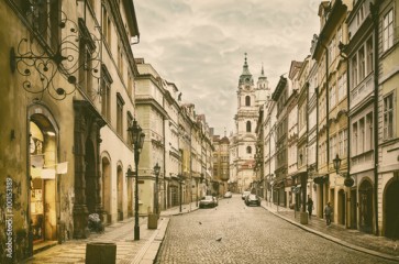 View to the street in the old center of Prague - the capital and largest city of the Czech Republic - vintage sepia retro travel background