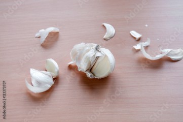 Purified head of garlic on a brown table