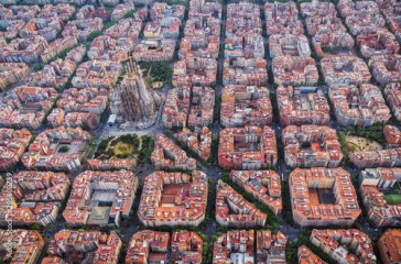 Aerial view of Barcelona Eixample residential district and Sagrada familia, Spain. Late afternoon light