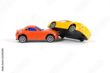 Car accident concept. Yellow and red toy cars on a white background