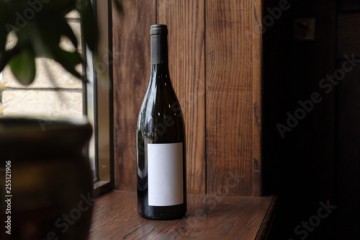 Bottle of red wine on wooden background. Blank Label for your text or logo. Mock up