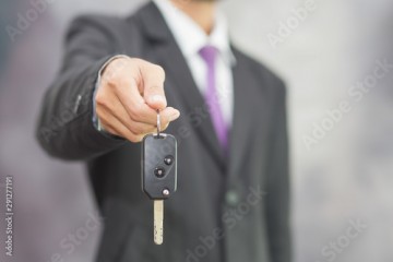 Businessman holding car key