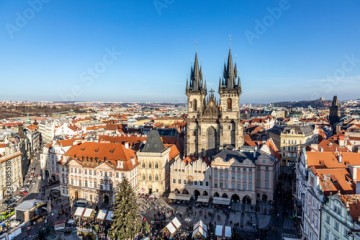 Old Town of Prague, Czech Republic. View on Tyn Church and Jan Hus Memorial on the square as seen from Old Town City Hall during Christmas market.