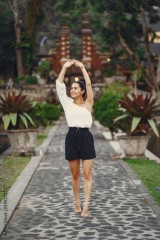 girl exploring a beautiful park in Bali. Brunette girl dressed in stylish clothing posing in a beautiful location