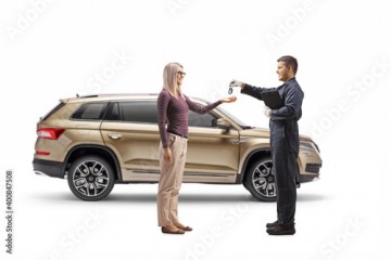 Auto mechanic returning keys from a SUV to a young woman