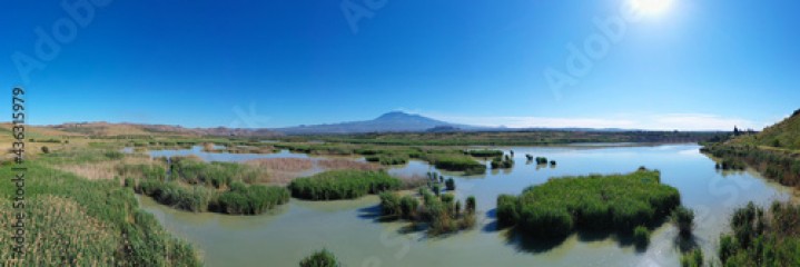 180 degrees aerial photo of the Oasis of Ponte Barca a protected area in the heart of Paternò in Sicily. Wetland that attracts numerous waterfowl. Nesting place of the Sultan chicken. Etna view.