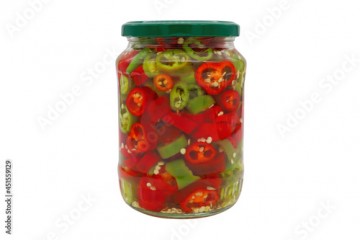 A jar of chopped hot peppers and pickles isolated on a white background