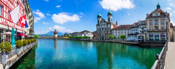 Panoramic view of Lucerne (Luzern) town with famous Chapel wooden bridge over Reuss river and Jesuit Church. Switzerland travel and landmarks.