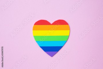 Love Valentines heart in rainbow pride colours on the pink background