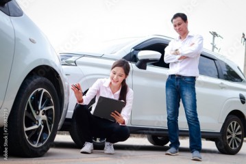 An Asian man driving a car had an accident and called the insurance agent for help. Transportation concept. car insurance