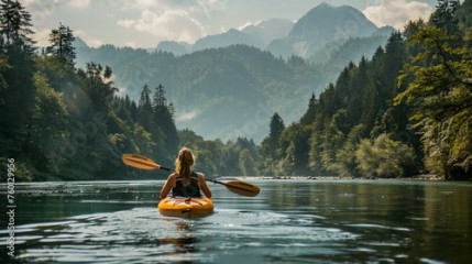 Kayaking on the river with a view of the mountains and forests