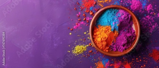 A bowl of colorful powder is on a purple background. The bowl is filled with a variety of colors, including red, yellow, and blue. Concept of creativity and playfulness, as the colors are bright