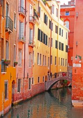 Italy. Venice. Canal with bridge among old colorful brick houses