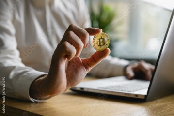 man holding bitcoin in hand. crypto buying and investment concept